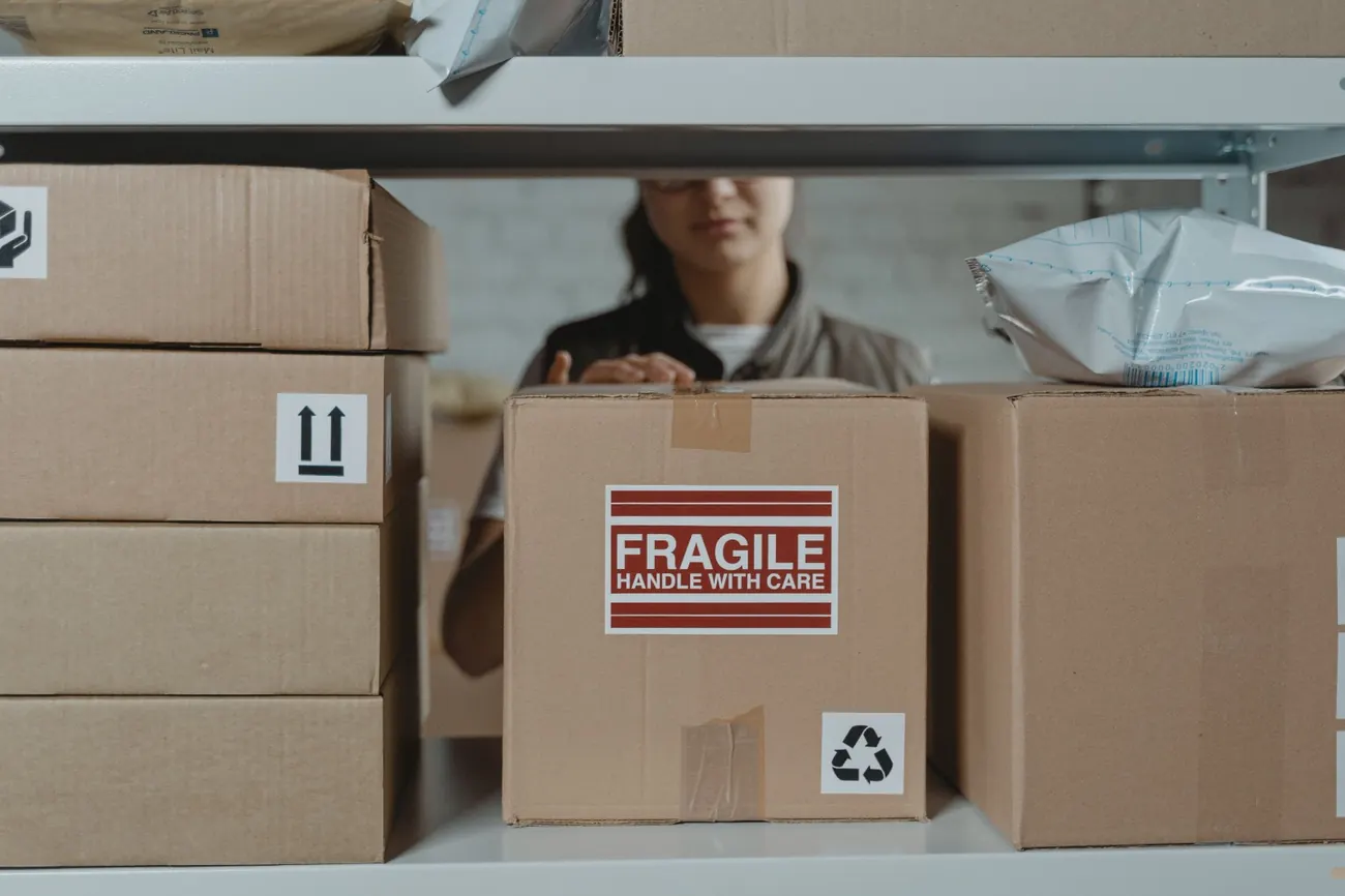 A box marked Fragile, handle with care, on a storage shelf